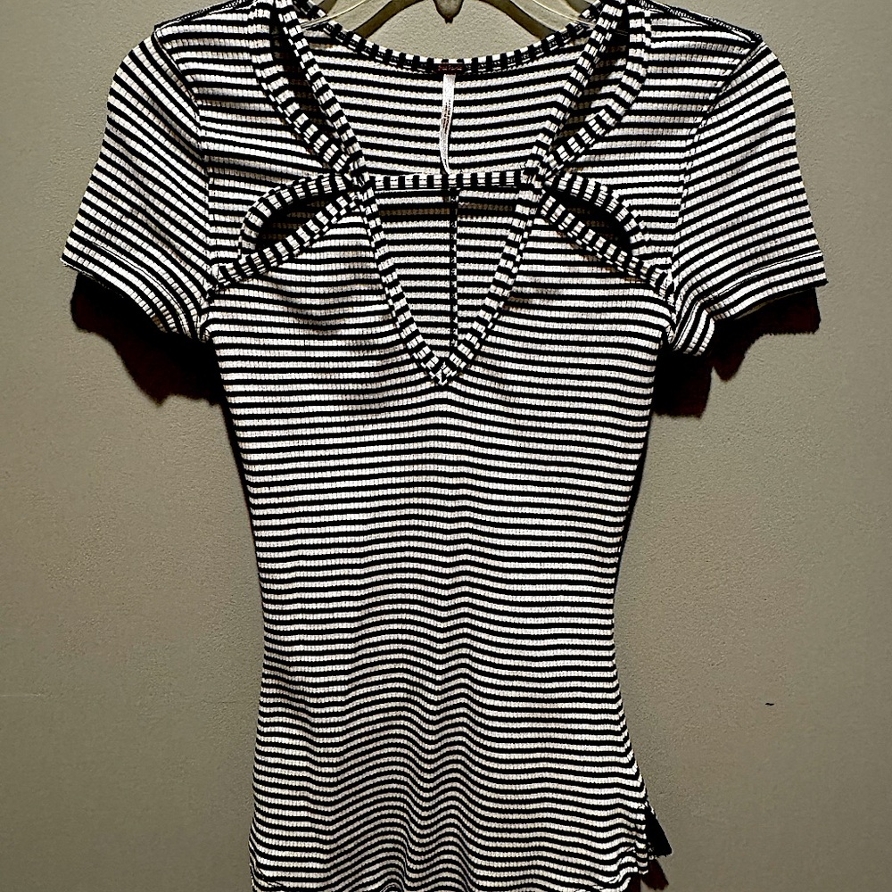 Black and white stripe Free People pullover shirt with cutouts.
